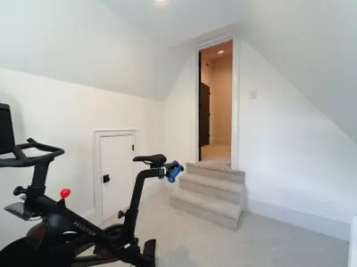 Park Road Attic Expansion Featuring a Private Gym by DGK Design + Build