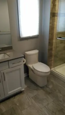 Gray Bathroom Renovation by Clarence by New York Kitchen & Bath