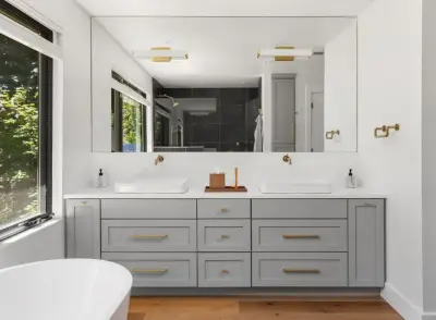 Charming Grey Bathroom Renovation by Miller & Sons Construction Group
