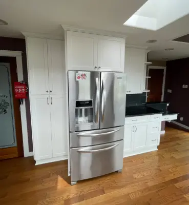 Bespoke White Kitchen Renovation Featuring Black Quartz Countertops by Emerald City Custom Cabinets