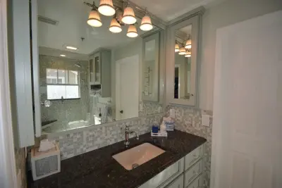 Tailored White Marble Bathroom by The Bath And Kitchen Gallery, Inc.
