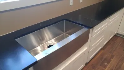 Farmhouse Kitchen Sink in White Shaker Style with Black Soapstone Countertops by ACE Cabinet Center