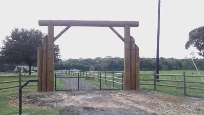Entry Log Gates — Custom Home Builders project by Newton Log Homes Construction