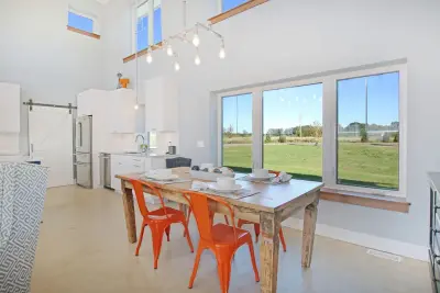 Contemporary Farmhouse Embracing Sunlight by R-Value Homes