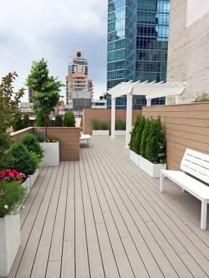 Midtown East, NYC Roof Garden Design: Composite Deck, White Planters, Pergola — Landscape Design project by Amber Freda Garden Design in New York