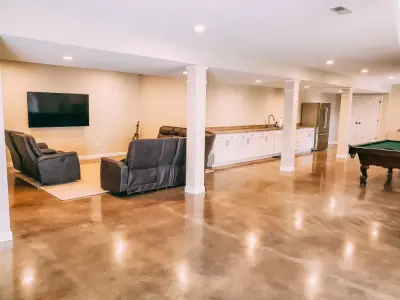 Refined Concrete Basement Renovation by Stockell Custom Homes & Construction