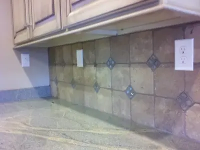 Tumbled Stone Kitchen Backsplash with Straight Lay Design by Floor Pro South, LLC
