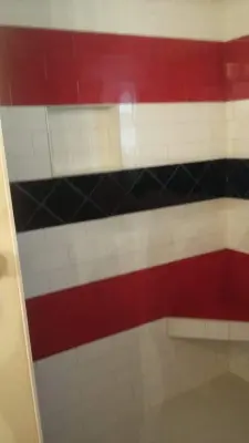 athletic-inspired personalized shower — Tile & Stone Installation Services project by Harris Flooring & More