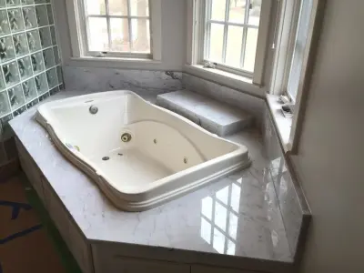 Italian Marble Bathroom Vanity and Jetted Tub Enclosure in Bianco Venatino by Ecstatic Stone, LLC