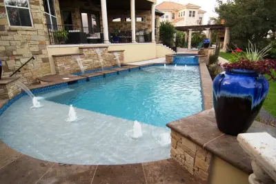 Cantera Stone Exterior Swimming Pool by Rustico Tile & Stone