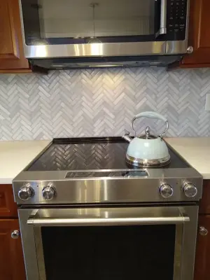 Herringbone Glass — Tile & Stone Installation Services project by VersaTile Interiors