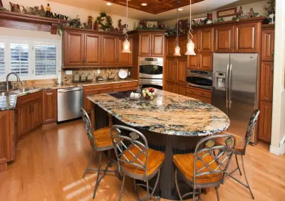 Kitchen with Dual-sided Granite Fireplace | Pueblo West, CO — Tile & Stone Installation Services project by Sol Granite & Natural Stone