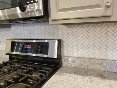 Thassos Herringbone Polished Marble Mosaic by Maravilla — Tile & Stone Installation Services project by Davey Tile