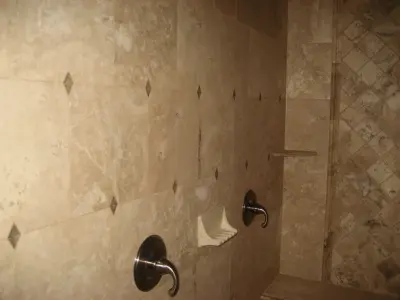 travertine bathtub and shower — Tile & Stone Installation Services project by Heinrichs Custom Tile And Stone