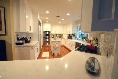 Complete White Kitchen Renovation by Flat Rate Remodeling, Inc.
