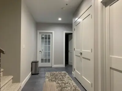 Basement Renovation: Newly Constructed Bathroom and Laundry Area by K & M Flooring-Renovations Inc.