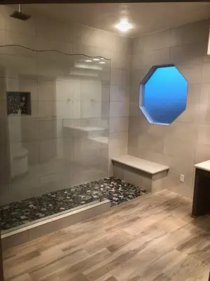 Bathroom with Wood Flooring by Enchantment Design & Remodeling, LLC