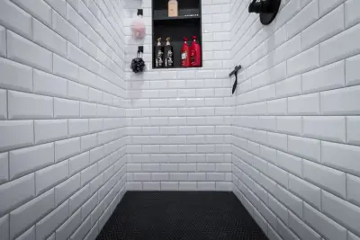 Brass and Black Bold Bathroom by NextGen Remodeling LLC