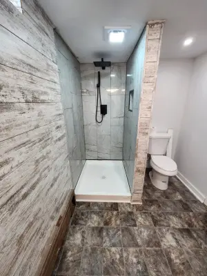 Contemporary Approach to a Basement Bathroom Renovation by Haight N' Sons LLC