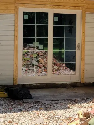 Removed fireplace and installed French doors by A & T Designs And Remodel