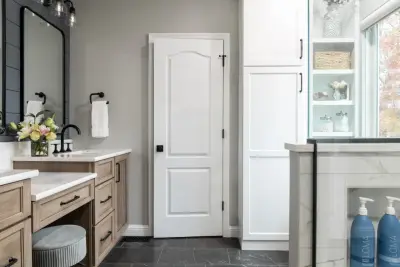 Stylish bathroom featuring smart storage solutions and artistic design elements by Liston Design Build