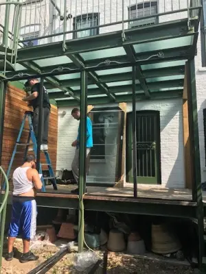 Brooklyn Brownstone PGT EZE-Breeze Steel Deck Patio Cover — Window Installation & Replacement project by Uneeda Home Improvement Co., Inc