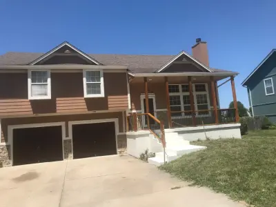 Revamped front porch featuring new cedar posts and metal spindles, with all rotting wood removed — Kitchen Remodeling project by Diamond Design & Build LLC