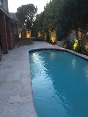 Pool, Travertine Patio and Outdoor Kitchen by Artscape Land Design