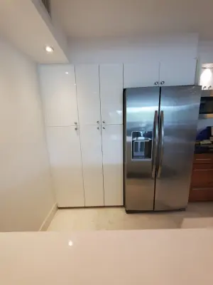 Contemporary Kitchen Renovation Featuring a Glossy White Finish — Kitchen Remodeling project by Kitchen Solvers Of Fort Lauderdale