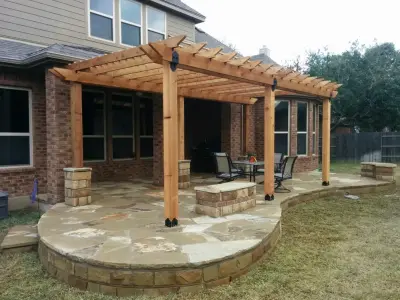 Tailored Mission-Style Pergola with Stone Patio and Seating by Capitol City Wood Works LLC