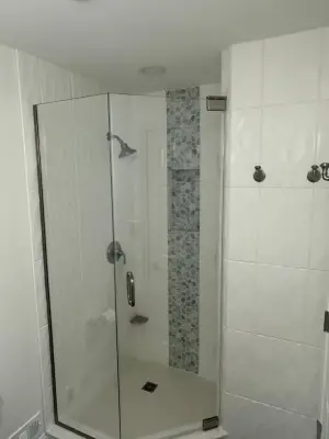 Compact master bathroom makeover featuring a bespoke tile shower and custom glass enclosure — Home Renovation & Remodeling Services project by Bolton Home Remodelers