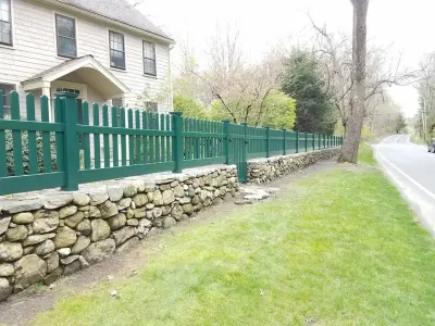 3’ Hunter Green Modern Picket Vinyl Fence Installed in Rock Wall by All American Fence Company