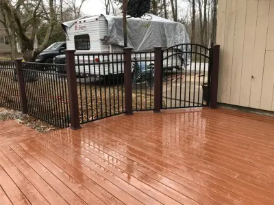 54-inch professional aluminum fencing project set up on 5x5 mahogany Woodgrain — Fence Installation project by All American Fence Company
