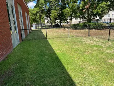Dark Chain Link Barrier and Entrance by My Garage And Gates