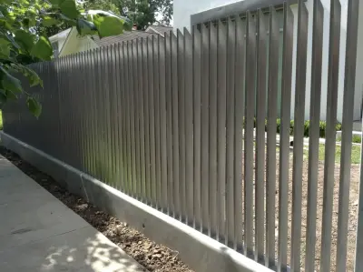 Vertical fence with automatic gate and concrete retaining wall — Fence Installation project by Architectural Fabricators