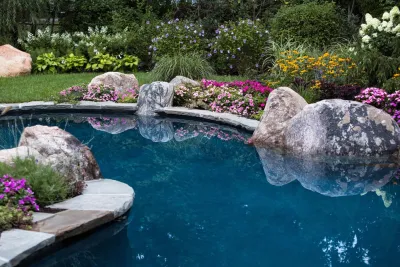 Custom garden pool with boulders and beautiful landscape by Thomas Flint Landscape Design & Development