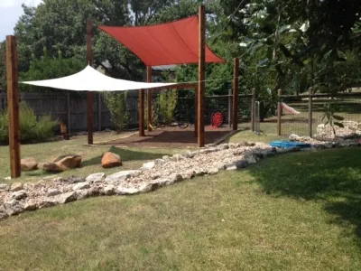 Child's Playset & Play area w/ Dry Creek — Landscape Design project by Blissful Gardens & Green Dragon Design in Austin