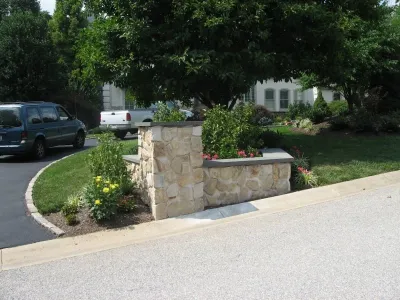Stone Veneer Driveway Entrance Garden Area with Pillar by Woodward Landscape Supply