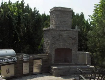 Outdoor Fireplace with Kitchen by Woodward Landscape Supply