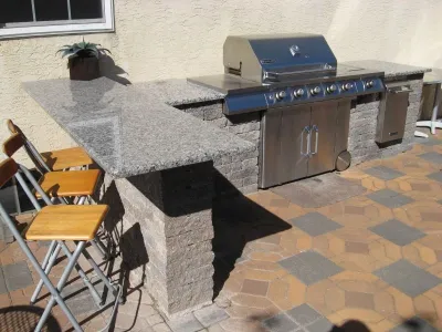 Outdoor Kitchen and Eating Area by Woodward Landscape Supply