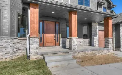 Custom Home with Wooden Pillars — Custom Home Builders project by Empire Homes And Remodeling Inc.