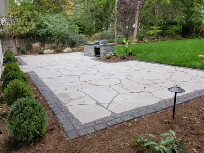 Irregular Blue Stone Patio with cobble border by Z.O. Landscaping