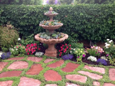 Mediterranean Succulent Garden with Repurposed Fountain by Alford's English Gardens Inc