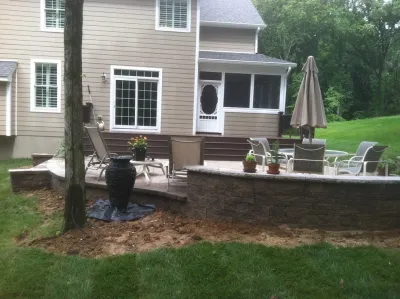 Gambrills, MD backyard retreat, composite deck, Techo-bloc patio and wall. 3D — Landscape Construction project by AMJ Lawn And Landscape, Inc.