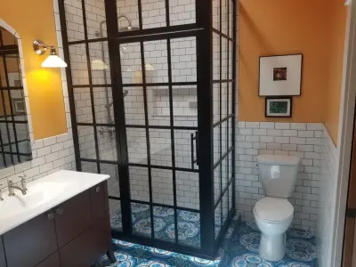 Heritage bathroom featuring Walker Zanger tiles and Gridscape shower glass by Coastal — Kitchen Remodeling project by Home Run Remodeling & Construction, Inc.