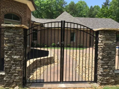 Real stone wall veneer around pool with fence — Landscape Construction project by Ayers Hardscapes & Landscapes LLC