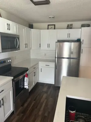 Kitchen Renovation with White Refaced Cabinets and Quartz Countertops — Kitchen Remodeling project by Kitchen Solvers Of Eau Claire