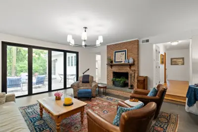 Warm Living Room Renovation Featuring a Brick Fireplace by Fine Remodeling