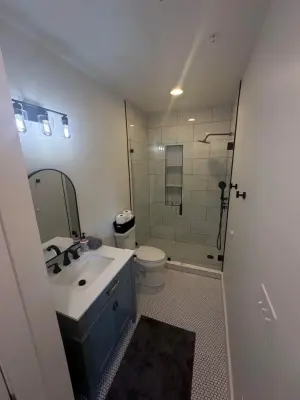 Guest Bathroom Renovation with Stunning Flooring and Tailored Shelving — Home Renovation & Remodeling Services project by JMH Custom Builders