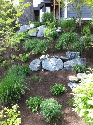Landscape and hardscape of hill by Classic Stonescaping & Gardens